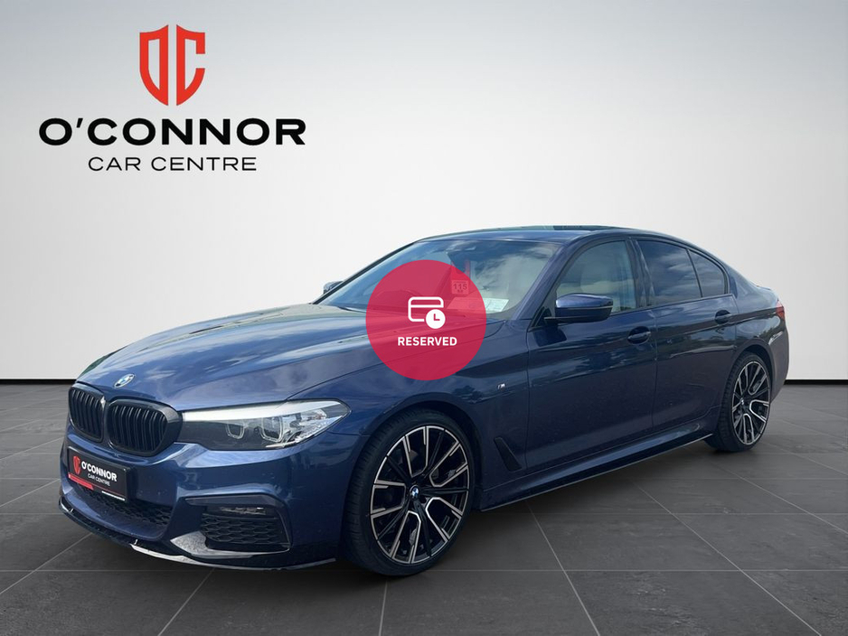 BMW 5 Series Navy suit, M Sport attitude — business class with a BMW badge.
